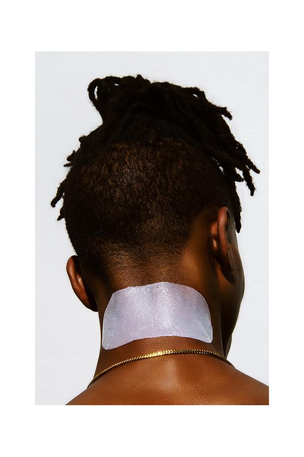 Man wearing ingrown treatment solution after shaving to treat ingrown hairs, razor bumps and irritation on neck.